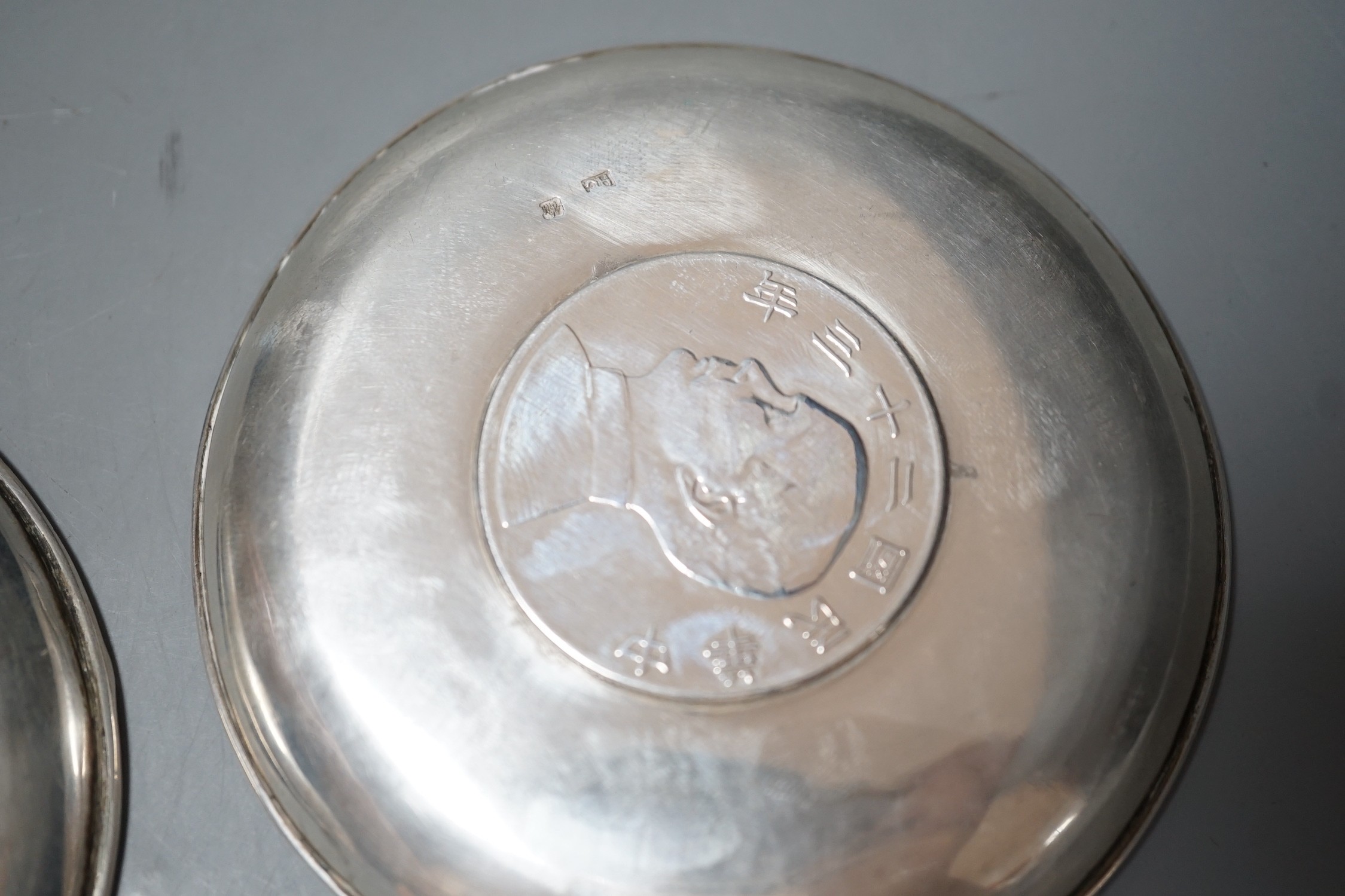 Three Chinese white metal dishes, each inset with coin, maker HC, 94mm, 196 grams gross.